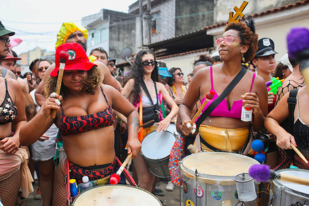 Two musicians drum at a carnival party organized in an outlying district of Rio de Janeiro. Ten days before the official launch of the Rio de Janeiro carnival, the street carnival has already begun. Held every year, Rio de Janeiro's Carnival, Brazil, is considered the biggest in the world, with around two million people in the streets every day. The official carnival parade in Rio de Janeiro's sambodrome in 2024 paid tribute to indigenous peoples and Afro-Brazilian culture with floats evoking Brazil's slavery heritage.