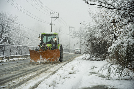 A snow-clearing machine removes snow from a street during snowfall. Fresh snowfall across the Kashmir Valley disrupted road, rail, and air connectivity forcing the closure of the national highway and leading to the cancellation of several flights at Srinagar airport, officials said.