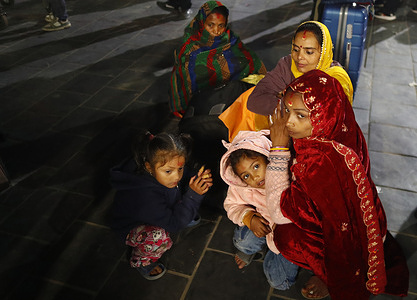 Passengers bound for the Middle East wait at Tribhuvan International Airport after flights were disrupted by regional airspace closures following escalating tensions and military strikes involving Iran, Israel, and the United States, in Kathmandu.