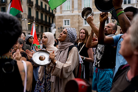 A woman seen chanting during the demonstration. Hundreds of people gather in Sant Jaume square in front of the town calling for a stop to the killing of civilians and journalists by Israel with its attacks in Gaza.