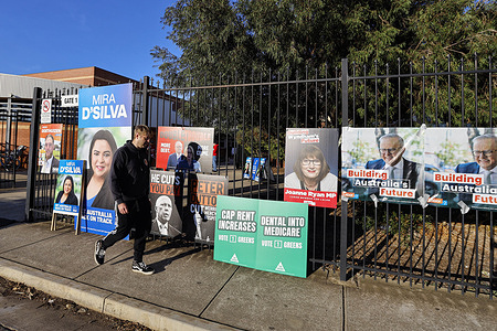 Campaign posters and signs are seen outside a polling centre on election day during the 2025 Australian federal election. The 2025 Australian federal election day begins today, 3 May, with voters heading to polling centres across the country to cast their ballots.