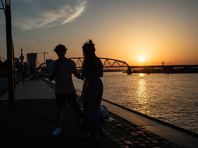 A couple seen taking a selfie during the sunset. The KNMI (Royal Netherlands Meteorological Institute) weather service has issued a code red warning for extreme heat for the first time, with temperatures expected to reach up to 40°C. Due to code red there is no school, events are cancelled, public transport adjusted, and cafes and bars will be open only for a few hours.