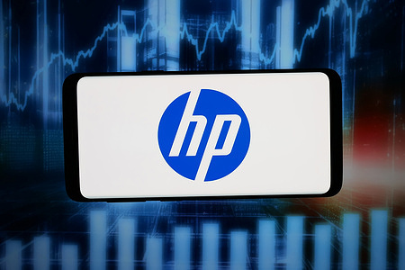In this photo illustration, the logo of US information technology company HP Inc. is displayed on a smartphone in front of abstract background on computer screen.
