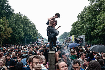 Revelers dance in the heart of Berlin at the Brandenburg Gate during the “Rave the Planet” festival. Thousands gather in central Berlin to celebrate electronic music, freedom, and unity during one of Europe’s largest street parades, as the streets pulsate with energy and DJs spin live sets beneath vibrant lights.