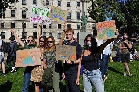Protesters hold placards expressing their opinion during the demonstration.
Over 200 protestors gathered in Parliament Square while demanding government action over climate crisis.