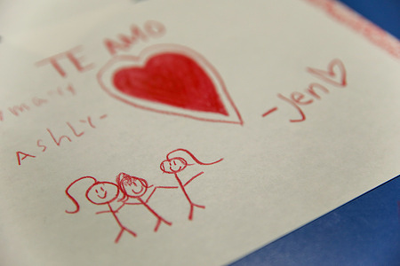 A drawing was left behind by a young girl in the dining hall of the Church of St. Francis Xavier, in Manhattan while her parents, recent immigrants to the United States, received legal and administrative assistance from the New Sanctuary Coalition. Once a week, the New Sanctuary Coalition mobilizes volunteers to assist migrants who must handle their immigration cases prose: that is, without a lawyer and representing themselves. New Sanctuary Coalition is a New York-based organization that offers support to immigrants facing deportation and detention.