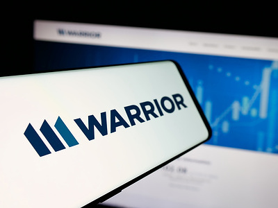 In this photo illustration, a smartphone with the logo of US mining company Warrior Met Coal Inc. is seen on screen in front of website.