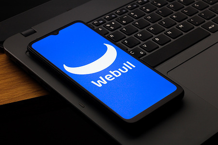 In this photo illustration, the Webull Corporation logo is seen displayed on a smartphone screen.