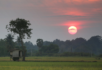 A sunset seen over a cottage in Nakhon Sawan province, north of Bangkok.