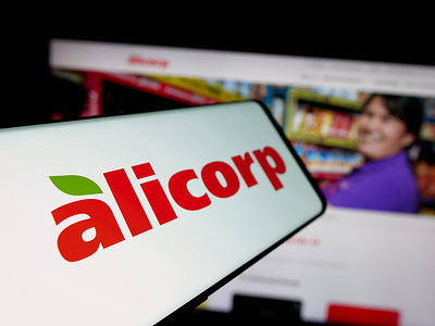In this photo illustration, a smartphone with the logo of consumer goods company Alicorp S.A.A. (Peru) is seen on screen in front of website.