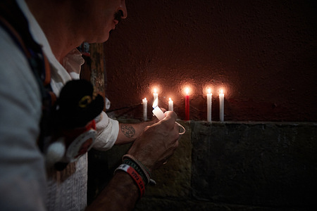 An assistant to the Poor Me, puts his candle remembering all those who are no longer there, ending the festivities of San Fermin 2023. At midnight, hundreds of people gather in the town hall square to sing songs of the Poor Me, light candles and hold up their red scarves to mark the end of the San Fermín festivities 2023.