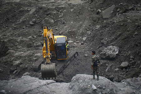 An excavator seen operating outside the Upper Trishuli 3B Hydropower Station, 16 days after a deadly flash flood and mudslide in Nuwakot. According to authorities, six workers are believed to be trapped inside the tunnel.