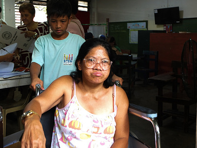 A young boy pushes a wheelchair for his mother after voting. Midterm elections were held in the Philippines on May 12, with candidates competing for 18,320 positions, including 12 Senate seats, 329 in the House of Representatives, and various municipal government posts.