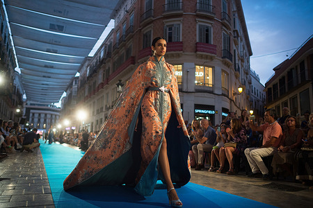A model presents a creation of fashion designer 'Romeo Couture' as she takes part in the 'Larios Malaga Fashion Week Catwalk' at Marques de Larios street. For two days, Malaga city welcomes the XI edition of Larios fashion catwalk, where fashion firms will walk through its main street for more than 300 meters. Fashion designer Agatha Ruiz de la Prada and fashion designers Victorio & Lucchino will be the prominent guests in this edition.