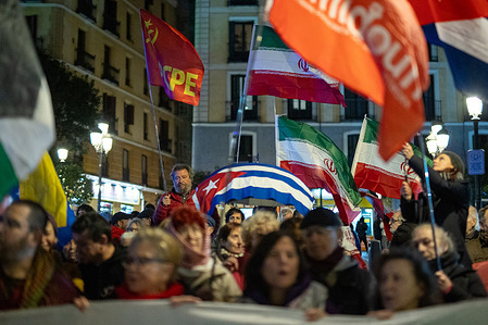 A protester raises a Cuban flag during a rally in Madrid's Lavapiés square "against fascism, imperialism, and war," organized by the Madrid with Palestine platform in support of the people of Cuba, Venezuela, Iran, Palestine, Lebanon, and all those attacked by the US and Israel.