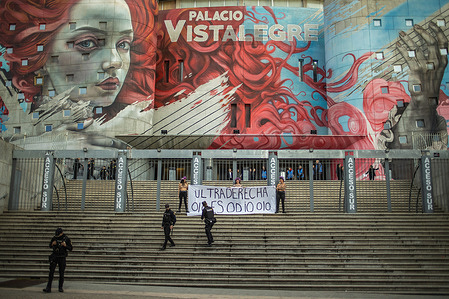 A group of police officers seen during an action by Femen Spain activists. Femen Spain activists chained themselves to the gates and unfurled a banner with the slogan "Far-right is hate" at the main entrance of the Vistalegre Palace where the President of Argentina, Javier Milei was scheduled to give a speech and close the "Madrid Economic Forum 2026." The forum will bring together economists, business leaders, politicians and far-right activists.
