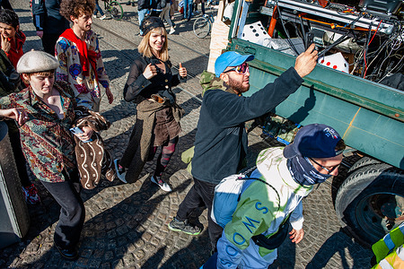 A group of protesters seen dancing behind one of the trucks with a sound system installed during the rally.
Thousands of people accompanied by trucks with loud music danced through the center of Amsterdam. ADEV (Amsterdam Danst Ergens Voor) means 'Amsterdam Dances For Somewhere'. Every year, the ADEV demonstrators dance for creative free spaces in the city. This year, also they protest against the housing crisis, because of that the theme was stop the Monopoly game in Amsterdam.