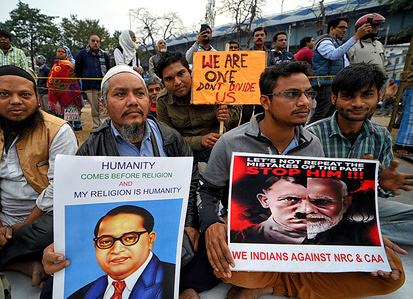 Protester holding a placard comparing Indian Prime minister to Adolf Hitler while seated during a demonstration against Citizenship (Amendment) Bill or CAB which grants Indian citizenship to non-Muslims of Afghanistan, Pakistan and Bangladesh that was passed by the Indian Government in December 2019 and has created violence, strike and protest all over the India.