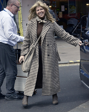A beaming Kate Garraway leaving Global Radio today after reports that Liam Halligan who is an old friend of her husband Derick Draper had confirmed that they are getting close.