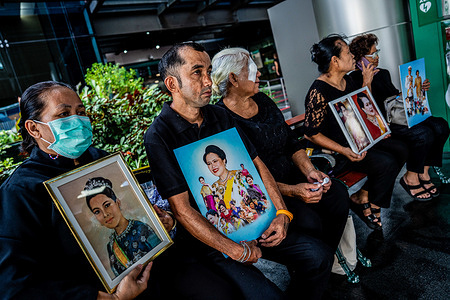Mourners hold portraits of Her Majesty Queen Sirikit, the Queen Mother, and the late King Bhumibol Adulyadej outside Chulalongkorn Hospital in Bangkok, following the announcement of the Queen Mother's passing. Thais gathered in front of Chulalongkorn Hospital in Bangkok to pay tribute to Her Majesty Queen Sirikit, the Queen Mother, who passed away on October 24, 2025, at 9:21 p.m. Tears, royal portraits, and prayers filled the air in a moving display of loyalty and affection toward the “Mother of the Nation".