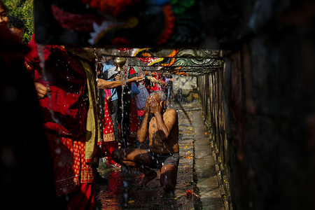 Nepalese devotees take a holy bath from 22 stone taps during Baisdhara mela Full Moon festival. Thousands of devotees gathered to take a holy bath in 22 waterspouts Balaju for their spiritual purification and in the belief it will treat many diseases.