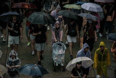 A woman pushes a baby stroller under the rain during the demonstration.
Protesters took to the streets on a rainy Sunday in a pro-democracy demonstration on Hong Kong Island, They demand the complete withdraw of the extradition bill and the government to set up an independent inquiry into the recent clashes between protesters and police - Organisers stated that this was the largest rally during the week.