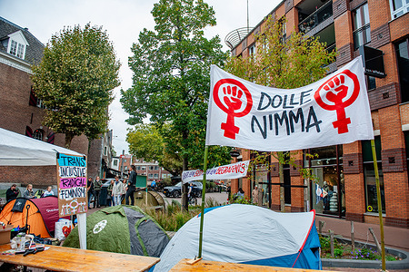 General view of the banner with the symbol and name of the feminist organization see during the rally. The feminist organization Dolle Mina is protesting against the lack of shelter spaces for victims of domestic violence by placing tents on the streets of several cities in the country.