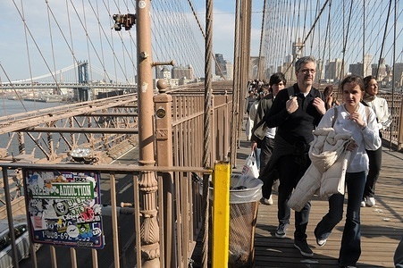People walk on the Brooklyn Bridge in New York City.