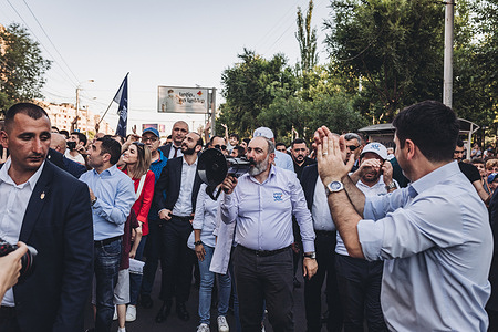 Nikol Pashinyan, main candidate of the Civil Contract party for the parliamentary elections in Armenia speaks through a megaphone to his supporters during a march through the streets of Yerevan.