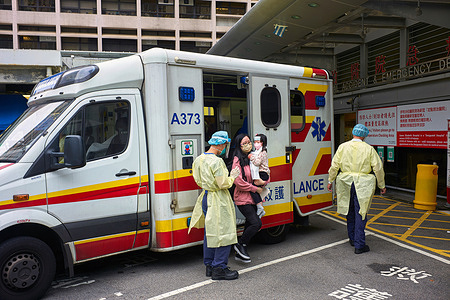 A mother and daughter get out of an ambulance at the emergency ward of the dedicated covid-19 patient hospital, Queen Elizabeth Hospital in Hong Kong during the coronavirus disease (COVID-19) pandemic.