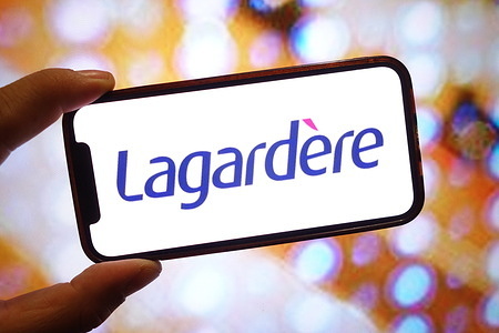 In this photo illustration, a Groupe Lagardere company logo is seen displayed on a smartphone screen.