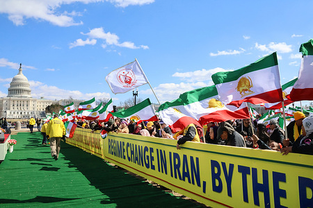 Iranians are seen waving Iran's flag with the sun and lion signs. Thousands of Iranian Americans, human rights advocates, and supporters of the National Council of Resistance of Iran (NCRI) gathered in Washington, D.C., calling for regime change in Iran. The rally, coinciding with International Women’s Day, highlighted the Iranian regime’s oppression of women and echoed Maryam Rajavi’s Ten-Point Plan for a democratic, secular, and non-nuclear Iran. Protesters urged the U.S. government to enforce maximum pressure policies and support Iranians’ right to overthrow the regime.