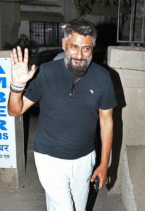 Director of the film 'The Kashmir Files' Vivek Agnihotri waves to the media in Mumbai. The director of the film 'The Kashmir Files' has been given security cover due to a threat received by him on social media after the release of his film.