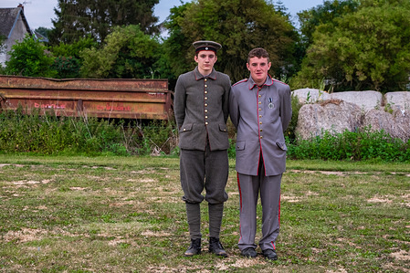 Two actors wearing vintage clothes are seen posing for the camera just before the start of a theatrical performance portraying the first world war. As every year in Pozièrs, a Son & Lumière (sound and light) theatrical performance takes place. This year the staging of the armed conflict of the First World War has special significance since it is centenary of the Great War. One of its bloodiest battlefields was in the Somme region. The play is performed on the same territory where the armed confrontations took place. Performances take place annually during 20,21,22 and 27,28,29 of July.