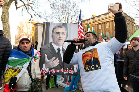 A protester chants slogans through a microphone during the demonstration. Iranian protesters gathered outside Downing Street in London following renewed anti-government protests in Iran, calling for the overthrow of the Islamic Republic and the reinstatement of the monarchy under Mohammad Reza Pahlavi. Demonstrators from the Iranian diaspora demanded political change, an end to repression, and international support for a return to a secular state and constitutional monarchy.