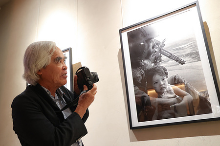 Vietnamese-American photographer Nick Ut stands to introduce his photography work while he attends an event at Siam Paragon, Bangkok. Nick Utt was identified as the photographer of “The Terror of War,” also known as Napalm Girl, in 1972 while working for the Associated Press. The image was named “Photo of the Year” in 1973. However, World Press Photo temporarily withheld his identification as the photographer, while the Associated Press has stated that there is no clear evidence to change the name.