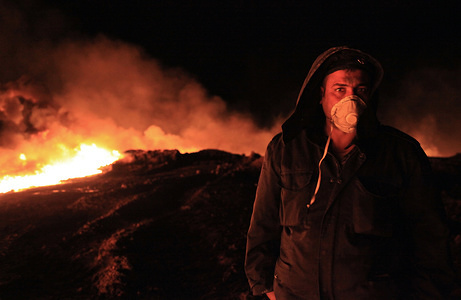 Iraqi local police guarding an oil well that was set alight by fleeing IS militants.
During the Iraqi advance against Islamic state occupied territories in the north of Iraq, IS militants set dozens of oil wells alight in an attempt to "blacken the sky" so that coalition planes were unable to strike fleeing IS convoys.