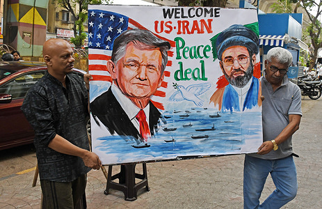 Teachers from the Gurukul School of Art carry a painted poster featuring U.S. President Donald Trump and Iran’s Supreme Leader, Mojtaba Khamenei, welcoming the peace agreement between the United States and Iran outside their school. US President Donald Trump announced a peace deal with Iran lifting the naval blockade in the Strait of Hormuz along with immediate and permanent end to military operations on all fronts including Lebanon.