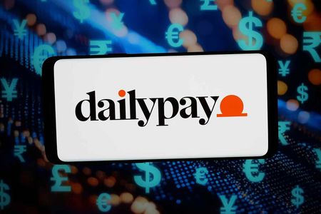 In this photo illustration, the logo of US on-demand payment company DailyPay Inc. is seen displayed on a smartphone in front of an abstract background on computer screen.