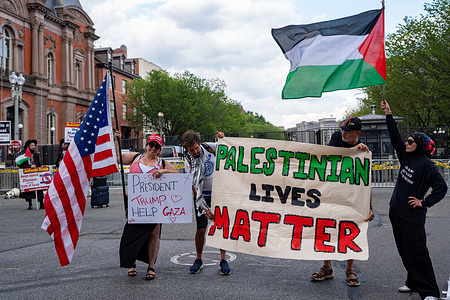 Protesters hold a banner, placard and flags on Pennsylvania Avenue outside the White House as the Israeli Prime Minister Benjamin Netanyahu meets with President Trump in Washington.