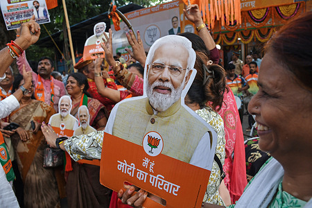 A supporter of the Bharatiya Janata Party (BJP) holds a cut out of India's Prime Minister Narendra Modi as they celebrate the victory outside the Bharatiya Janata Party (BJP) office. Supporters of Bharatiya Janata Party (BJP) in anticipation of Prime Minister Narendra Modi coming to power for the third time gathered outside the Bharatiya Janata Party (BJP) office to celebrate as the polling results slowly came to their climax.