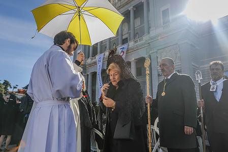 A parishioner receives communion during the mass for the Almudena Festival in the Madrid Cathedral.