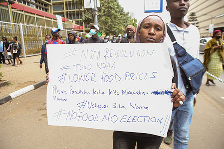 A Kenyan woman holds a placard with a message protesting the high cost of food prices, during a march to decry the high cost of living on Saba Saba Day. Kenyan activists from the Social Justice Centres Working Group organised the march on the streets of Nairobi with the purpose of drawing the government’s attention to the high cost of living being faced by Kenyans. Saba Saba day commemorates multi-party democracy protests and government crackdown in the 1990s.