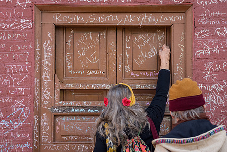 A foreigner writes on the wall of Swaraswati temple during the Shree Panchami festival.On Shree Panchami day, people especially children go to the temple for their first writing and reading lessons in belief that goddess Saraswati, the goddess of knowledge, wisdom and learning will help them excel in education.