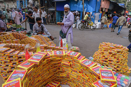A shopkeeper seen selling candles and special decorative lights to the customers on the occasion of Diwali at the Bara Bazar market. Shopkeepers are selling idols, clay lamps, decorative items on the occasion of Diwali in Kolkata. Diwali is a celebration of the day Lord Ram returned to his kingdom in Ayodhya with his wife Sita and his brother Lakshmana after defeating the demon Ravana in Lanka and serving 14 years of exile as per Hindu mythology.