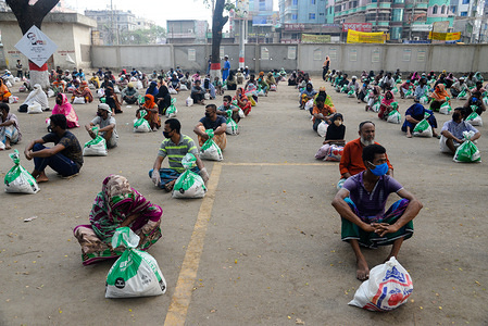 A group of people sit in a queue to receive relief supplies amid Coronavirus crisis.
During the Coronavirus crisis besides the government, many organisations are donating relief supplies to the vulnerable people in Dhaka.