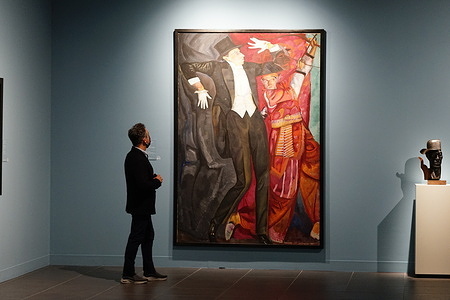 A guest observes an art piece during the inauguration of three temporary exhibitions; Vanguardias en el arte ruso', 'Maiakovski, artista y poeta' and 'Dostoievski en su bicentenario'; at Coleccion del Museo Ruso.