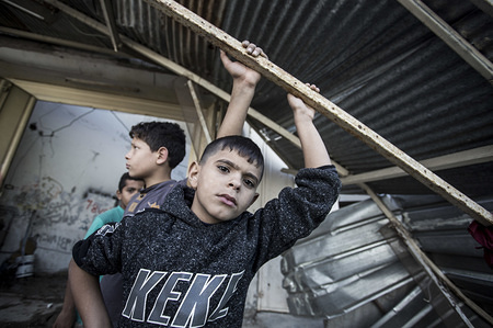 Two Palestinian boys seen at the site where the Israeli air force carried out airstrike in the early hours on Saturday.
Fighter jets and helicopters pounded targets in Gaza for more than two hours, including Hamas sites in response to the rockets fired into Israeli territories on Friday, the Israeli army said in a press release.