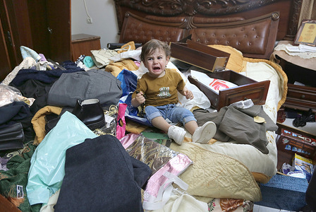 A Palestinian child cries amidst the damaged furniture after Israeli forces raided the house in the al-Masaken al-Sha'biya neighborhood east of Nablus in the West Bank, searching for weapons. The Israeli army continues its extensive searches for weapons in areas under the control of the Palestinian Authority.