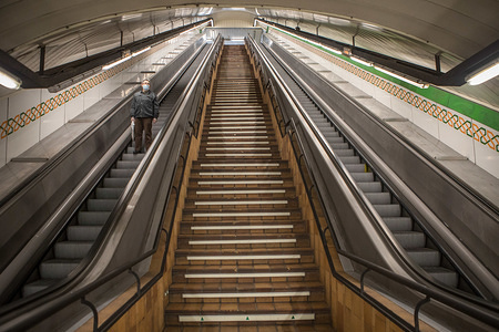 MADRID, SPAIN - APRIL 24, 2020: A man using the empty access escalators of the Madrid Metro Station during the covid 19 crisis.
Day 41 of the state of alarm due to the Coronavirus health crisis. Spain has had more than 200,000 confirmed cases of COVID-19 and over 20,000 reported deaths. Daily deaths from coronavirus have dropped in the last 24 hours to 367, the lowest rate in a month.